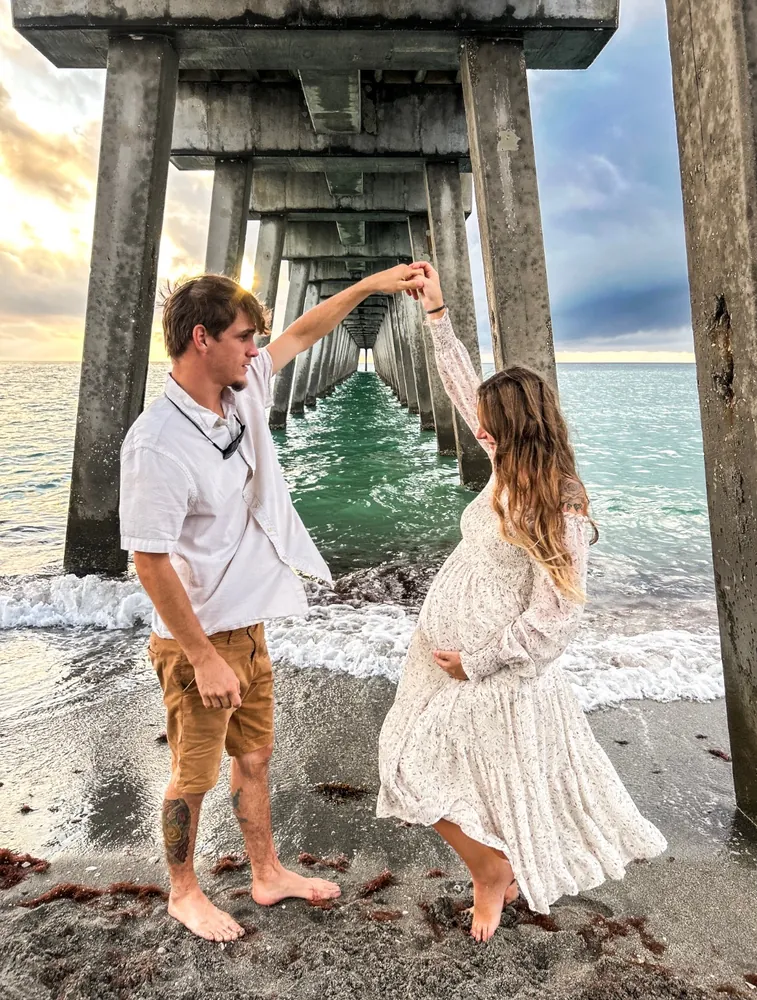 Couple dancing under the pier