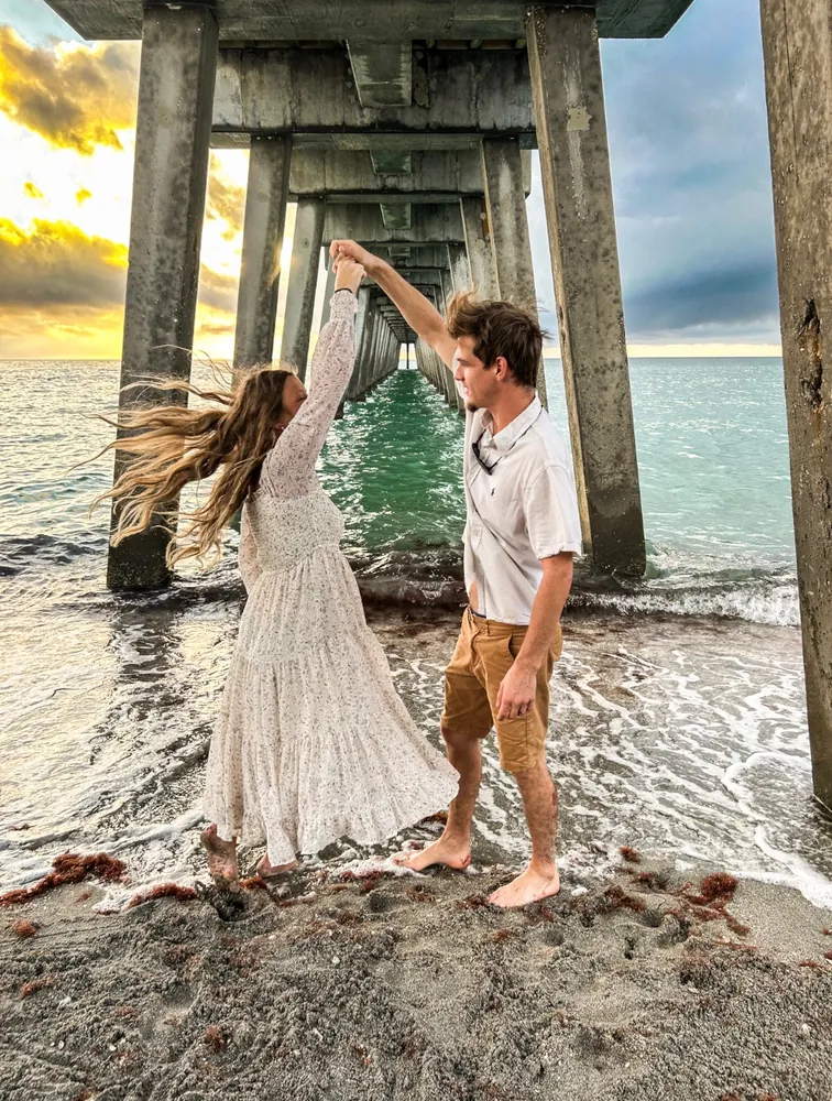Couple dancing at the water's edge