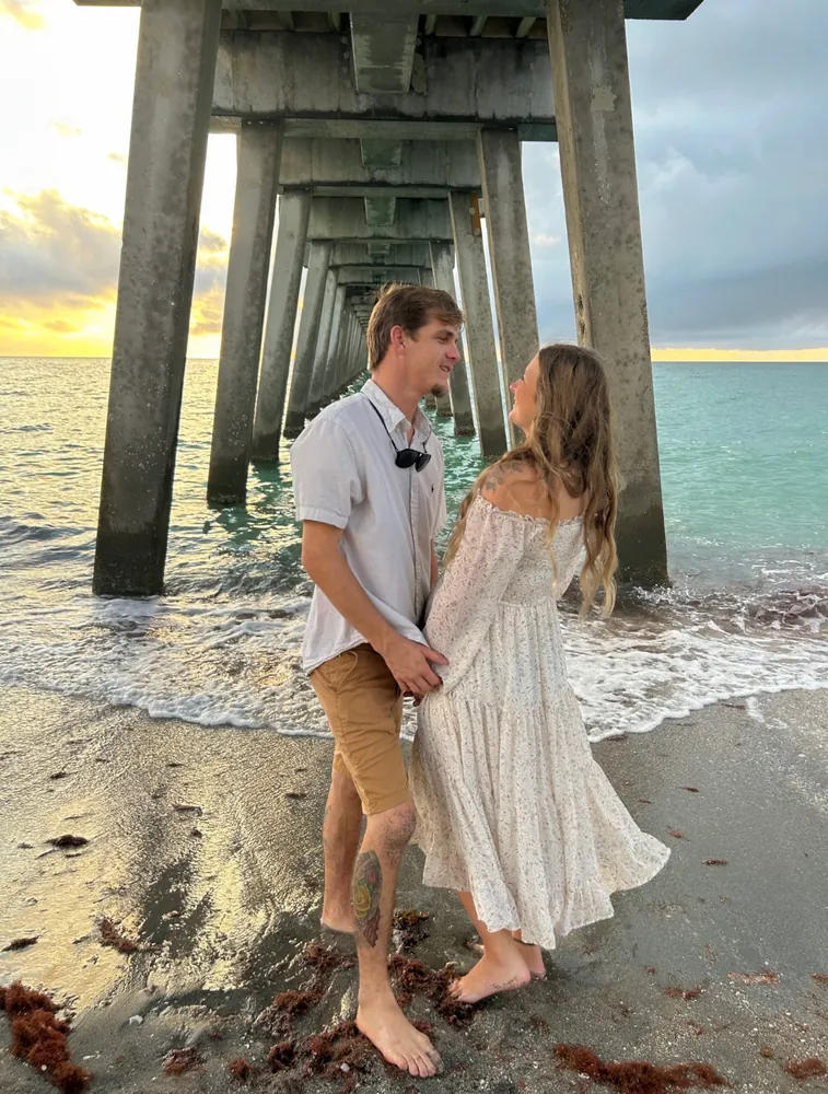 Couple holding hands on the beach