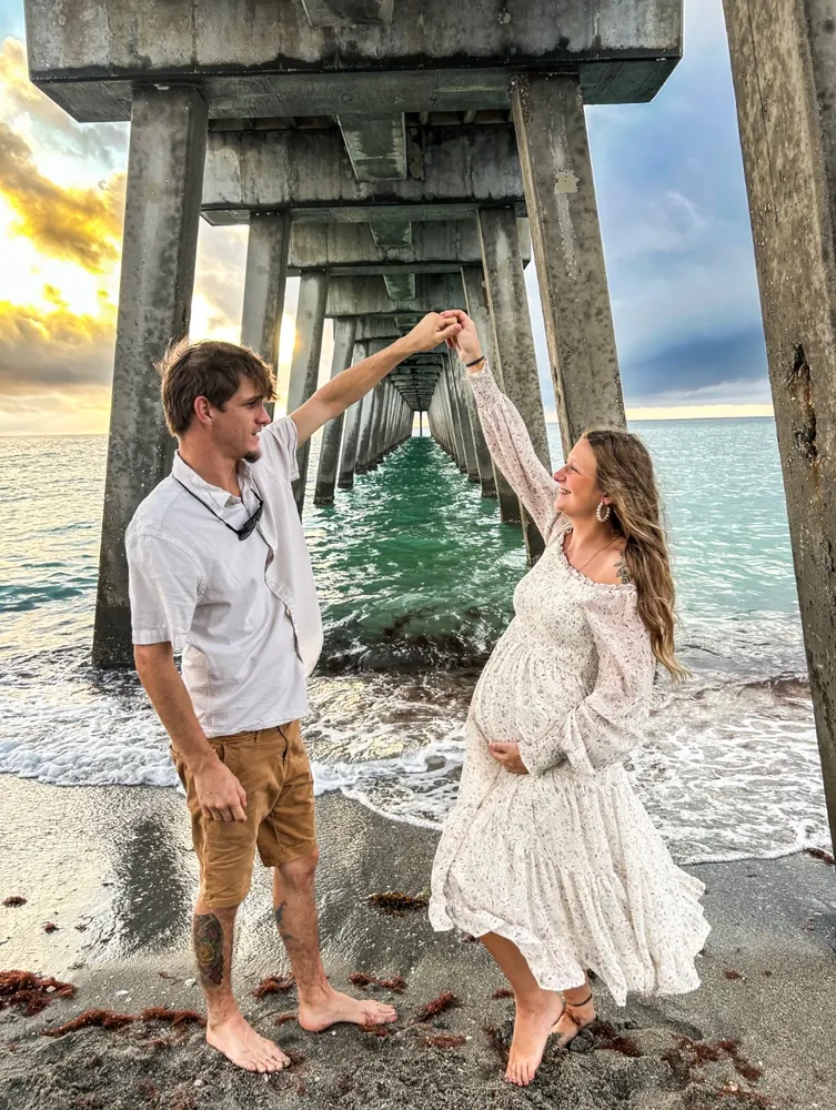 Couple twirling under the pier